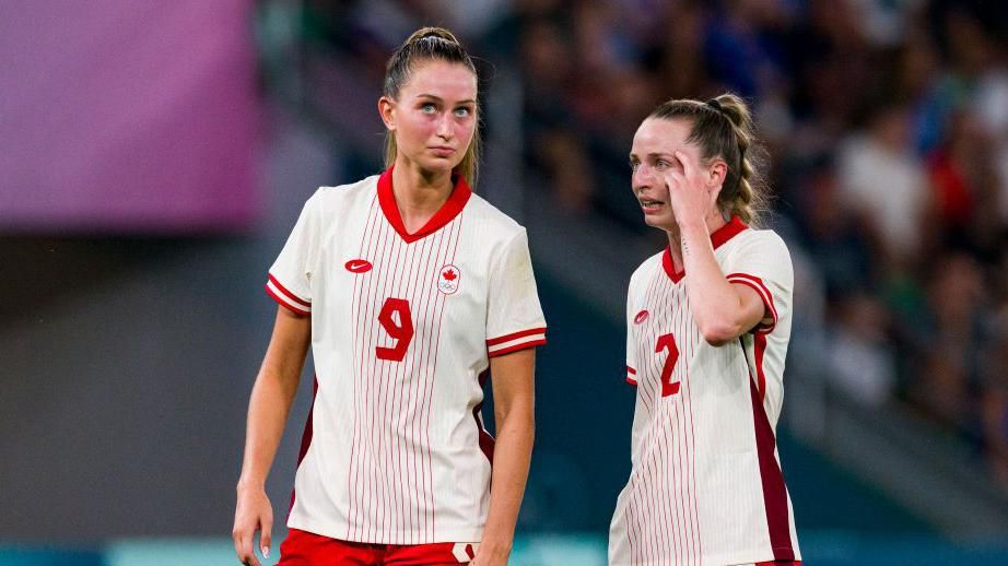 Two Canada players on the pitch