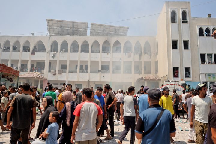 Palestinians inspect the damage following an Israeli strike on the Khadija school housing displaced people in Deir al-Balah, in the central Gaza Strip on July 27, 2024, amid the ongoing conflict between Israel and the militant Hamas group. (Photo by EYAD BABA/AFP via Getty Images)