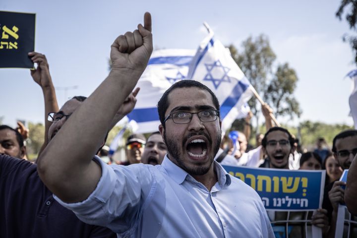 Far-right Israelis and relatives of the accused gather in front of the military court building in Netanya, Israel, on July 30, 2024 to protest against the arrest of nine soldiers charged with sexually abusing a Palestinian at the shadowy Sde Teiman Prison in the Negev desert.