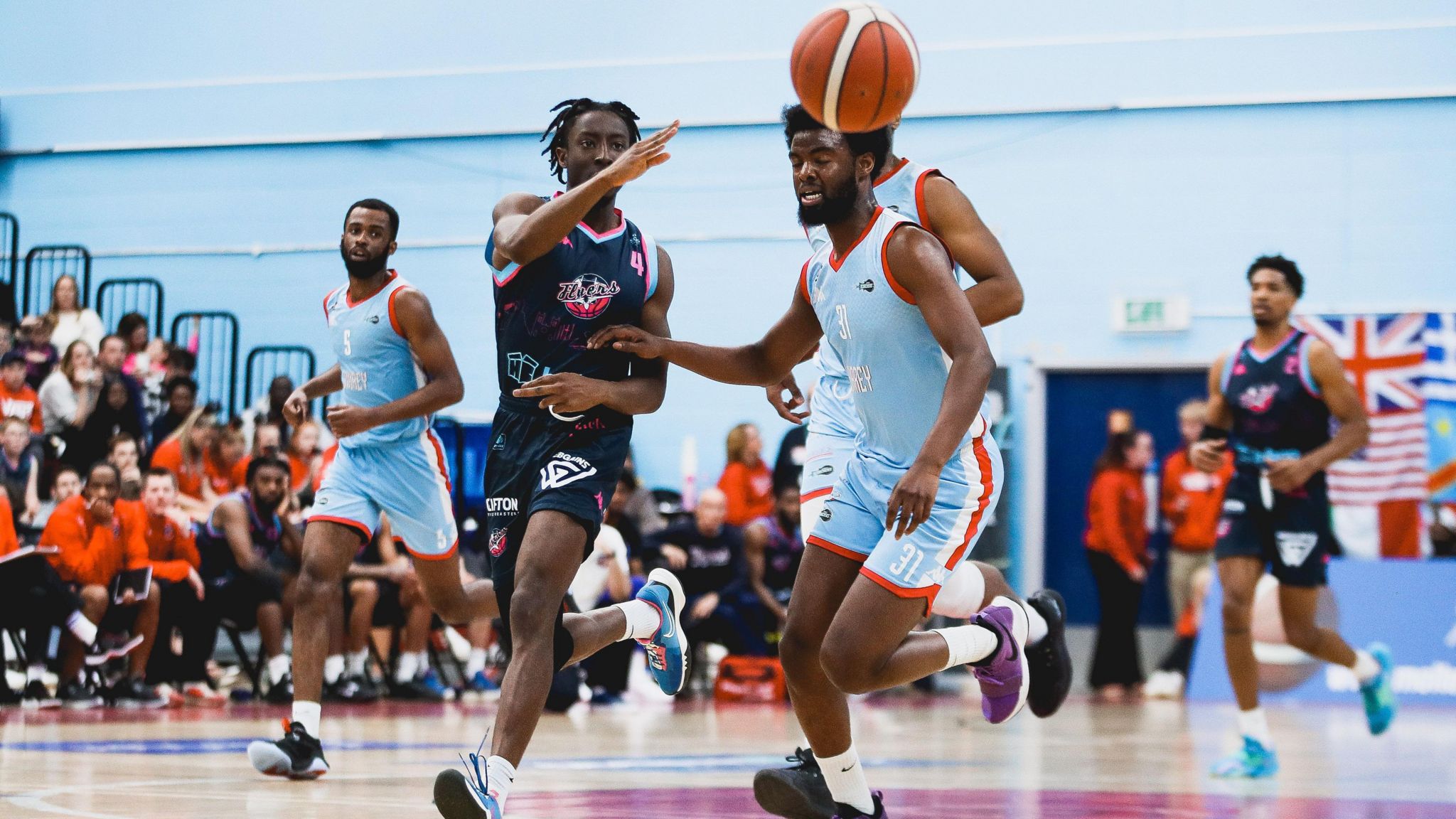 Surrey Scorchers and Bristol Flyers players challenge for the ball during a basketball match