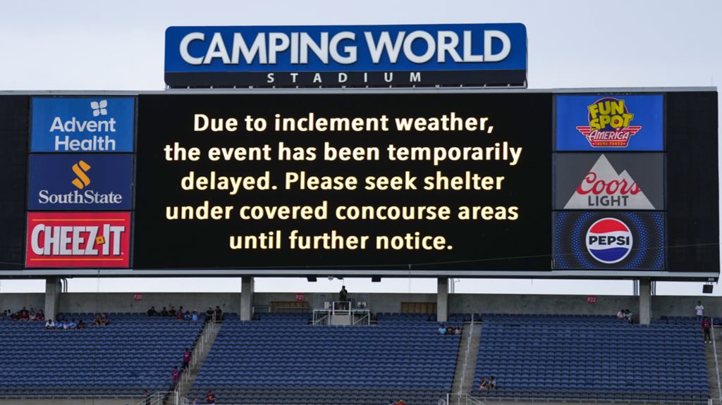 The scoreboard shows a delay in start because of inclement weather prior to a pre-season match between Manchester City and Barcelona