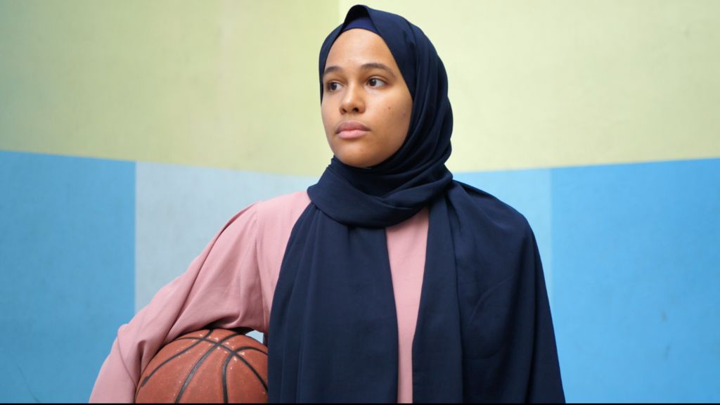 Helene Ba, co-founder of Basket Pour Toutes, with a ball under her right arm