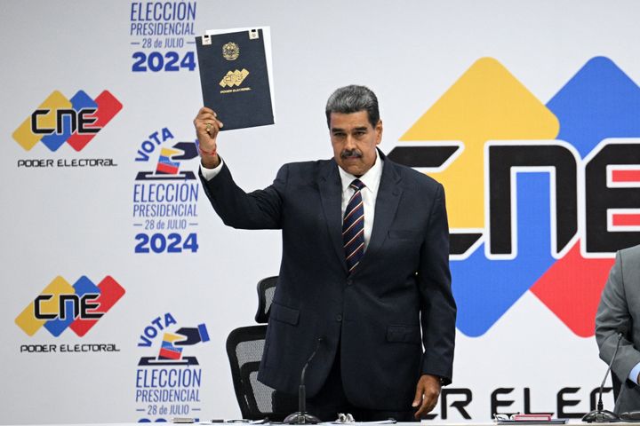 Venezuelan President Nicolas Maduro displays the document after being proclaimed winner of Sunday's presidential election, at the headquarters of the National Electoral Council (CNE) in Caracas on July 29, 2024, a day after the general vote.