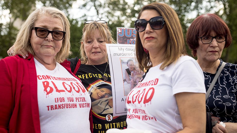 People affected by the infected blood scandal attend a vigil in Parliament Square on May 19, 2024 in London, England