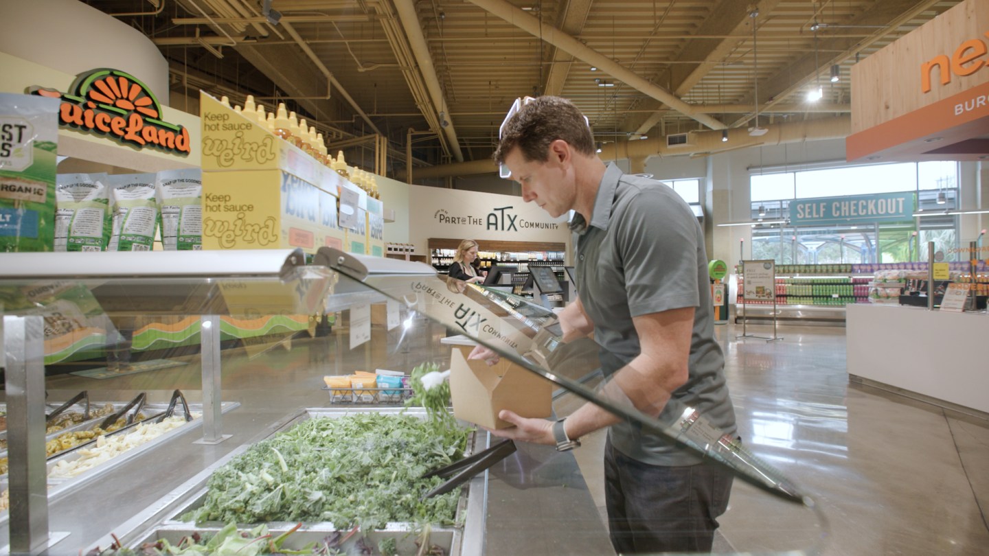 Jason Buechel getting lunch from Whole Foods' salad bar.