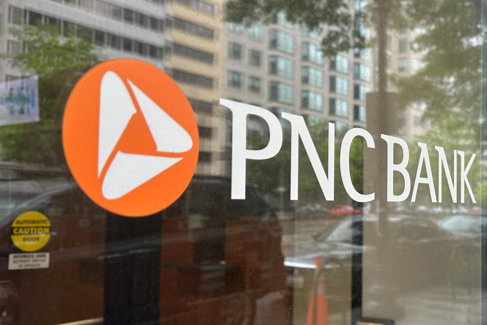 FILE PHOTO: The logo of PNC Bank, a subsidiary of PNC Financial Services Group, is seen on the window of a branch in Washington, U.S. April 30, 2023. REUTERS/Ashraf Fahim/File Photo