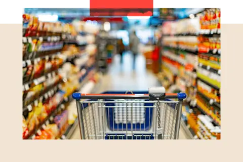 Getty Images A shopping cart in the aisle of a supermarket