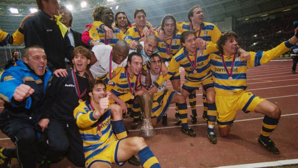 A Parma side including Gianluigi Buffon, Lilian Thuram, Fabio Cannavaro, Juan Sebastian Veron, Hernan Crespo, and Enrico Chiesa celebrate winning the Uefa Cup in 1999