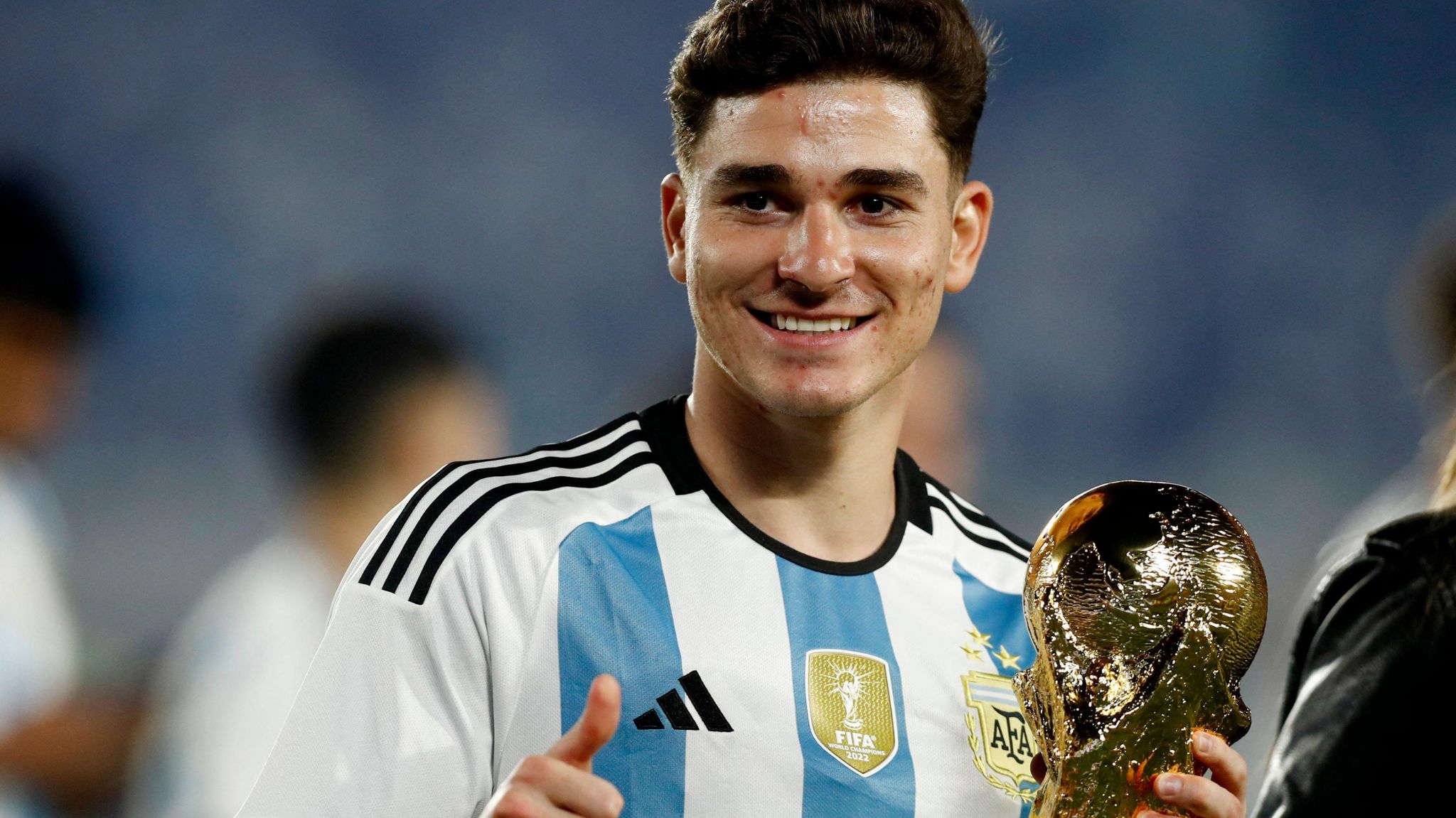 Julian Alvarez with the World Cup trophy