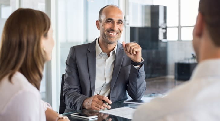 A financial advisor meets with a married couple about their long-term financial plan.