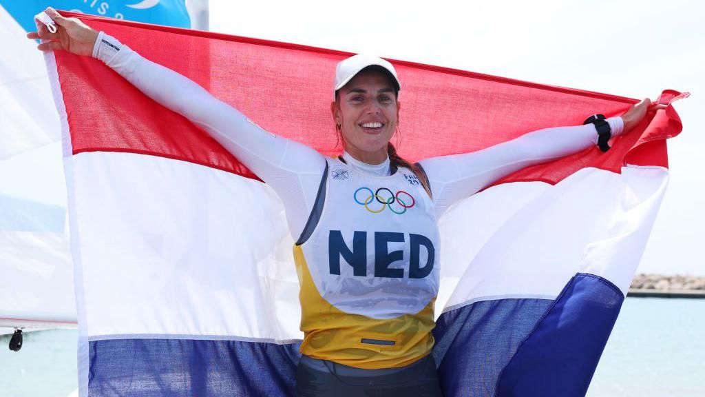 Marit Bouwmeester holds up the flag of the Netherlands