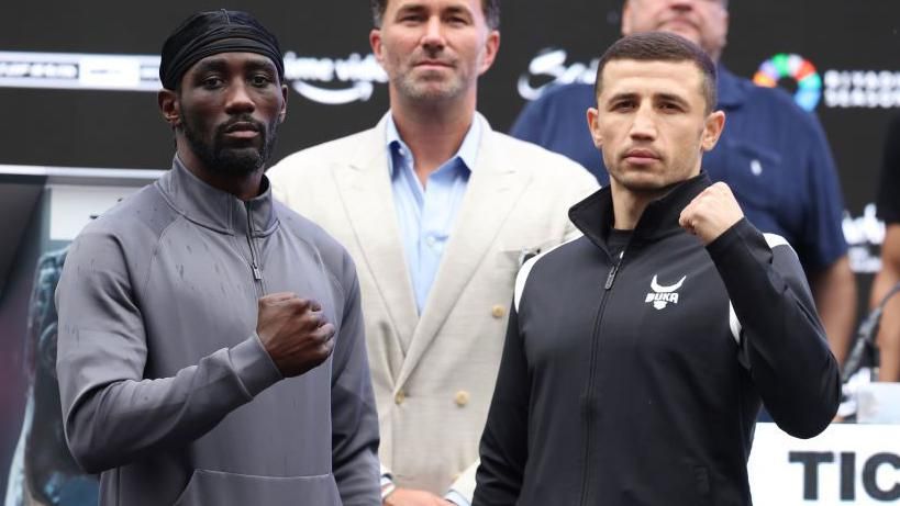 Terence Crawford holds up his fist beside Israil Madrimov doing the same 