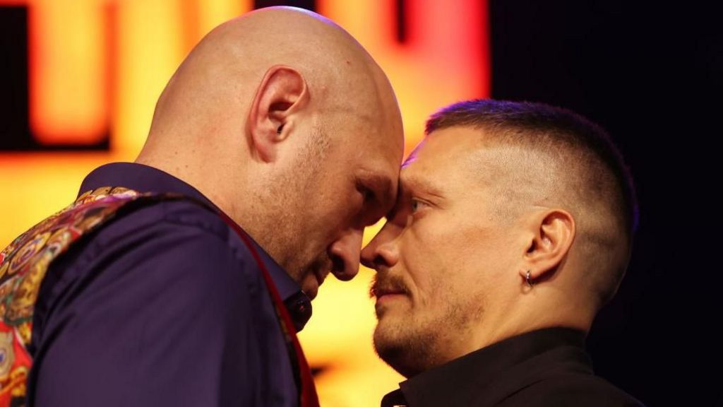 Tyson Fury touches his forehead against Oleksandr Usyk's during a face-off