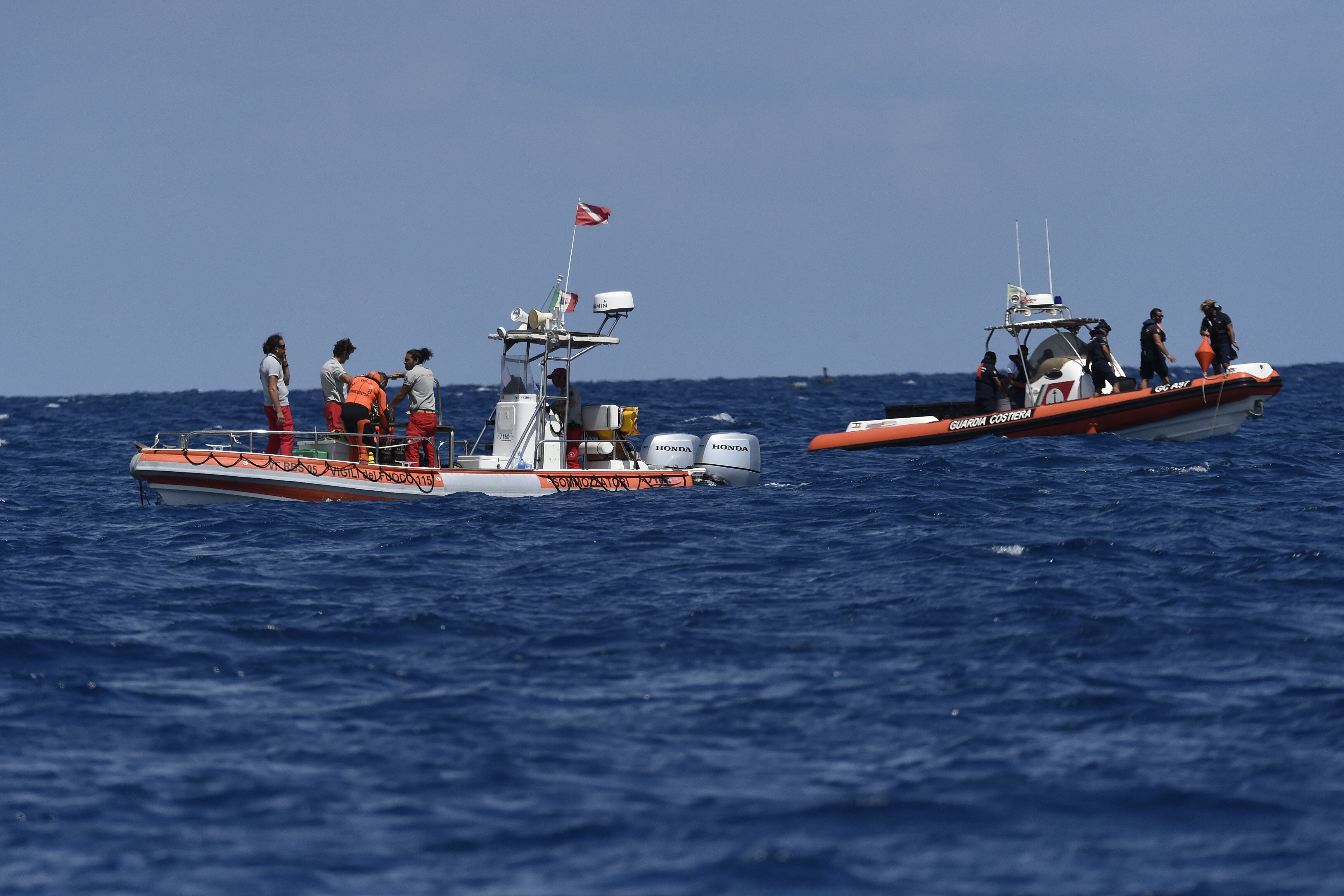 Scuba divers of the Italian Firefighters corp at the scene of the search for a missing boat, in Porticello, southern Italy, Wednesday, Aug. 21, 2024. (AP Photo/Salvatore Cavalli)