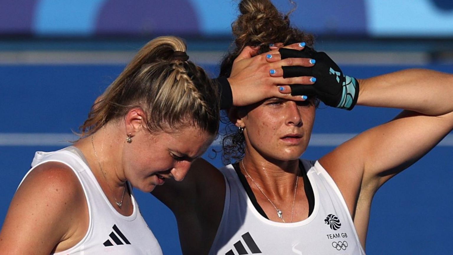 Lily Owsley and Flora Peel look on after Great Britain's loss to the Netherlands