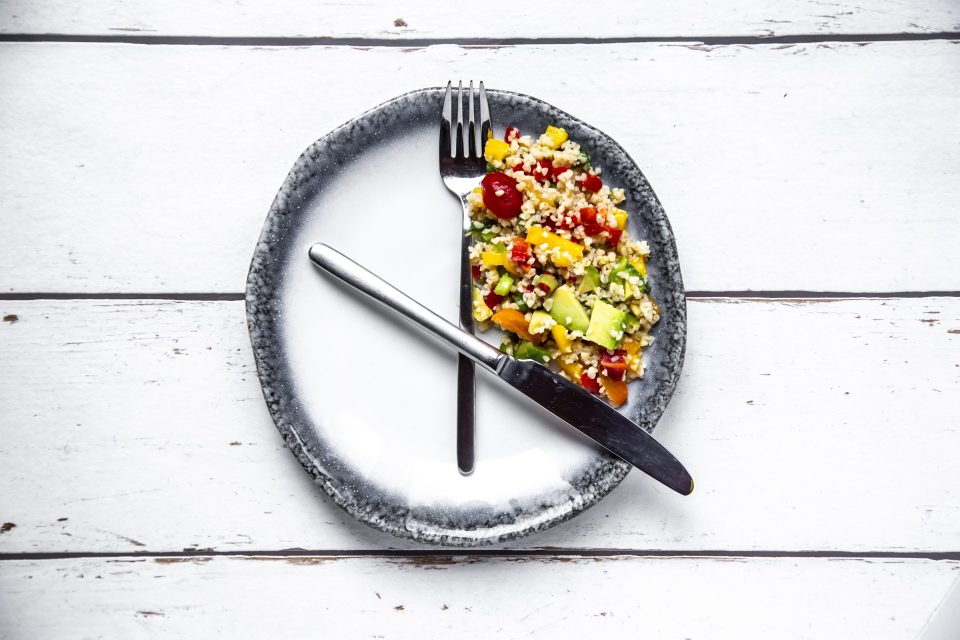 Bulgar salad on round plate, symbol for intermittent fasting.