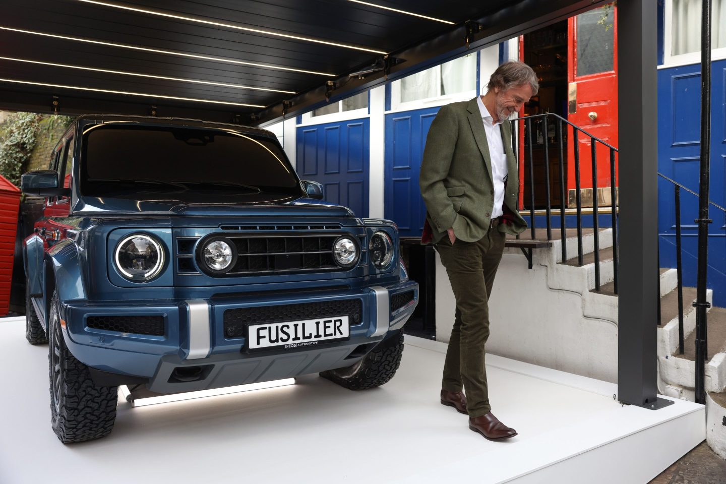 Billionaire Jim Ratcliffe, chairman and founder of Ineos Group Holdings Plc, alongside a model of the Ineos Fusilier electric sport utility vehicle (SUV), outside The Grenadier pub in London, UK, on Friday, Feb. 23, 2024. Ratcliffe's Ineos Automotive offered a first look Friday at the Fusilier, a sport utility vehicle smaller than the Grenadier 4x4 that the closely held company started selling early last year.