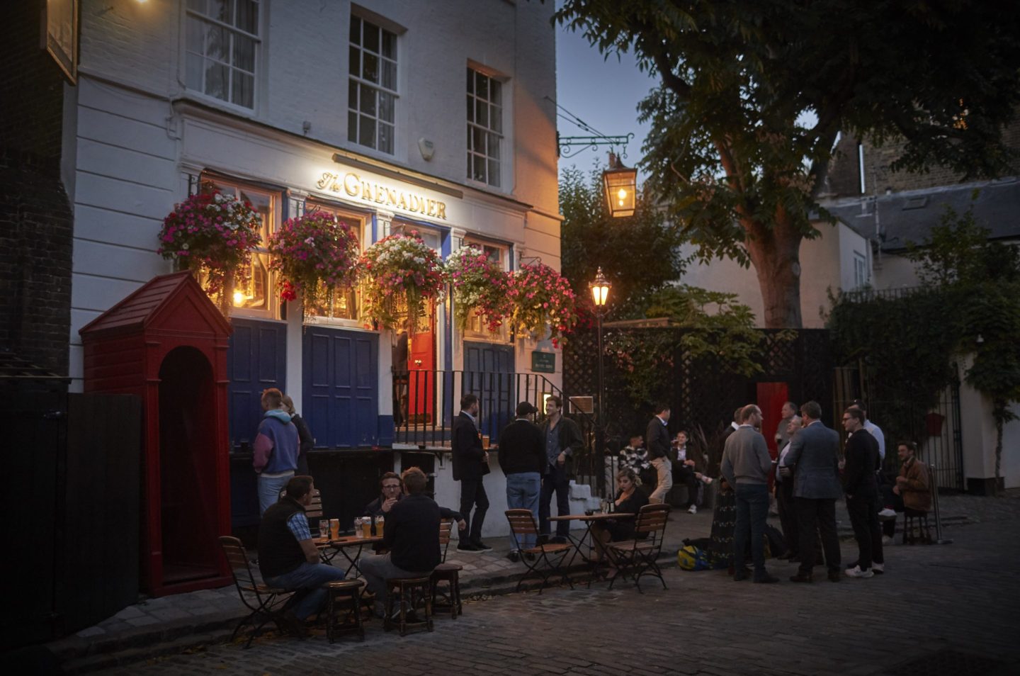 Patrons drink outside the Grenadier Pub in West London at the start of the weekend prior to the funeral of Queen Elizabeth II on Monday on September 16, 2022 in London, England.