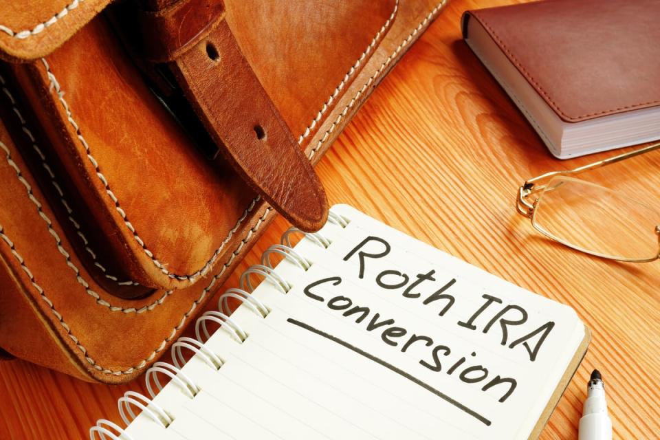 A notebook with the words Roth IRA Conversion written on a page.