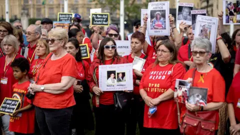 Getty Images People affected by the infected blood scandal attend a vigil in Parliament Square on May 19, 2024 in London, England. 