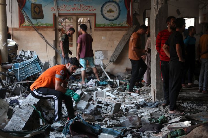 People check the damage inside a school used as a temporary shelter for displaced Palestinians in Gaza City, following an Israeli strike on August 10, 2024, that killed dozens of people. (Photo by Omar AL-QATTAA / AFP) (Photo by OMAR AL-QATTAA/AFP via Getty Images)