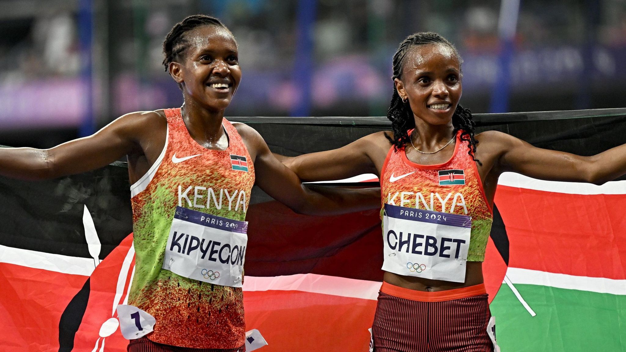 Faith Kipyegon and Beatrice Chebet pose with Kenyan flags