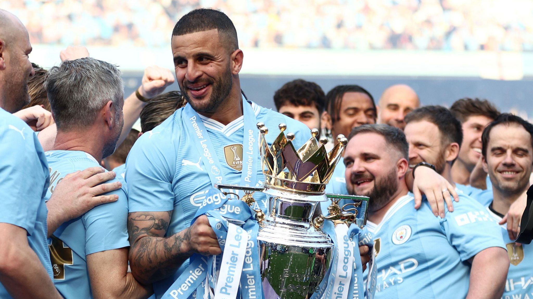 Kyle Walker holds the Premier League trophy after winning it with Manchester City