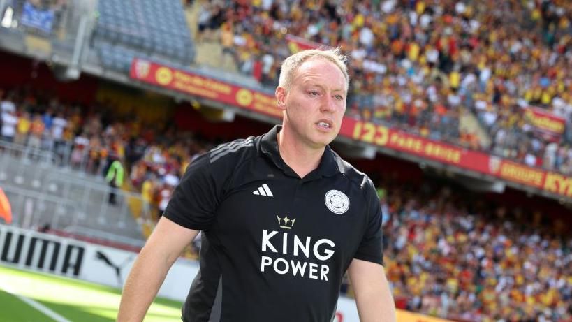 Steve Cooper walks on the edge of the pitch during a recent friendly