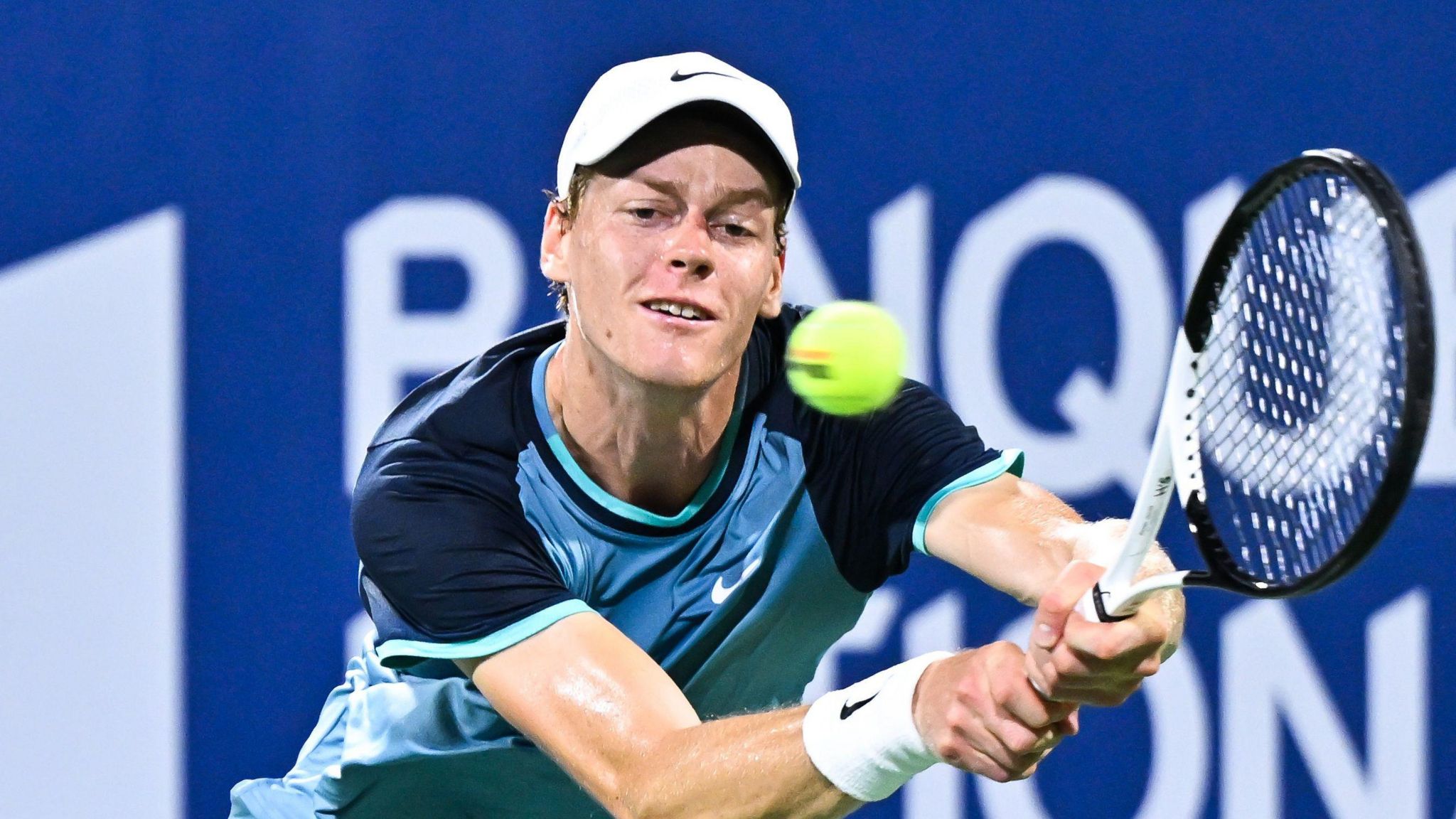 Jannik Sinner hits a backhand against Andrey Rublev