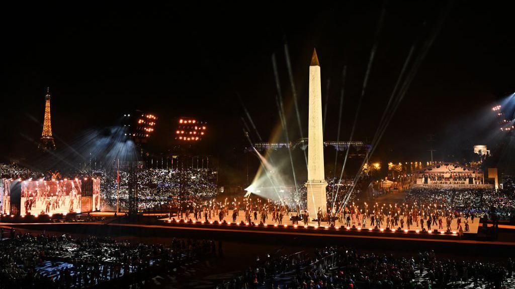 Dancers performs in front of the Luxor Obelisk at the Place de la Concorde