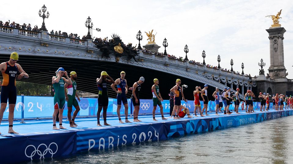 Triathletes line up for the swim leg of the men's race during the Paris 2024 Olympics