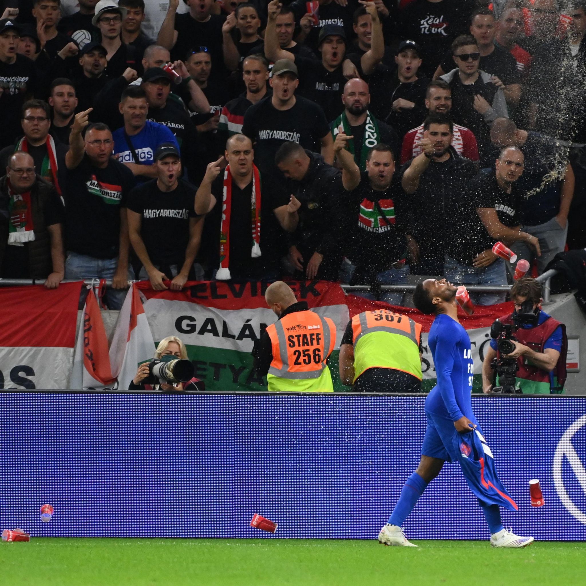 Raheem Sterling is showered by beer cups as Hungary fans swear at him as he celebrates