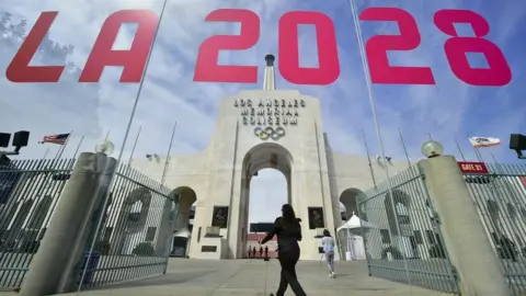 Getty Images The entrance of Los Angeles Memorial Coliseum is reflected on a window that has "LA 2028" written on it