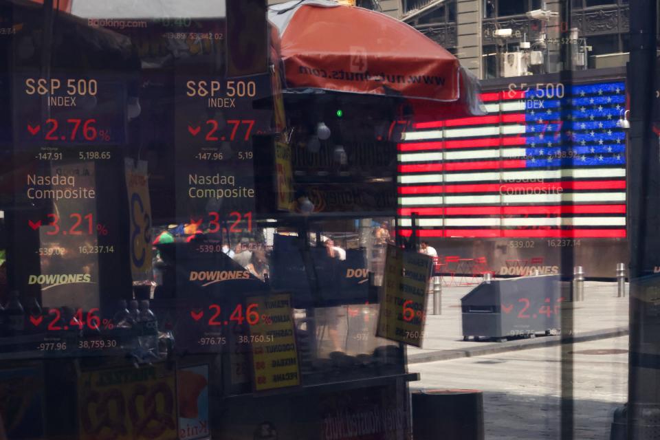 Stock market statistics are displayed in the window of the Nasdaq MarketSite in Times Square in New York City on August 5, 2024.