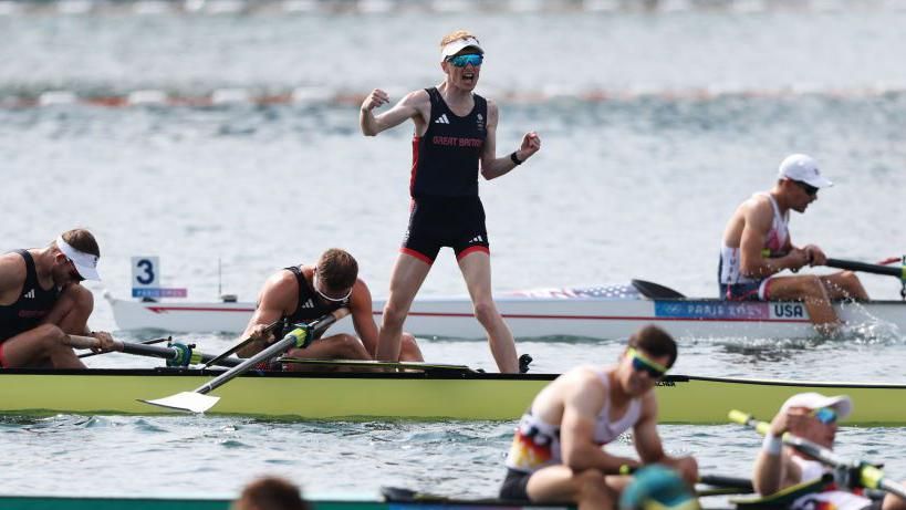 Team GB cox Harry Brightmore celebrates their gold medal in the men's eights