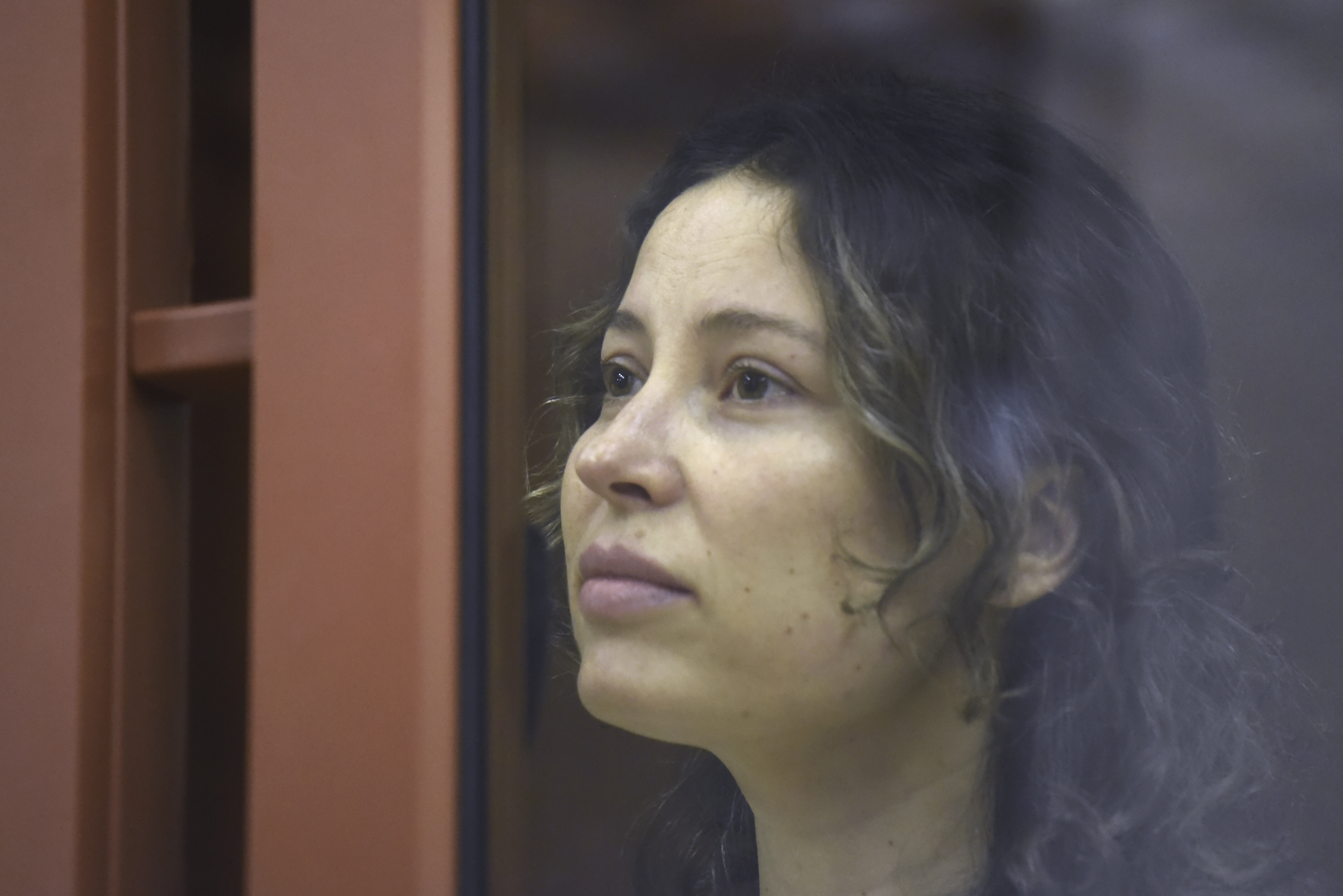 Ksenia Karelina, also known as Khavana sits in a glass cage in a court room in Yekaterinburg, Russia, on Aug. 15, 2024. 