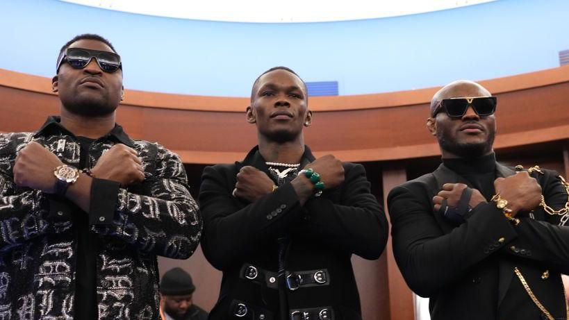 Francis Ngannou, Israel Adesanya and Kamaru Usman pose for a photo in the locker room before UFC 281 in November 2022