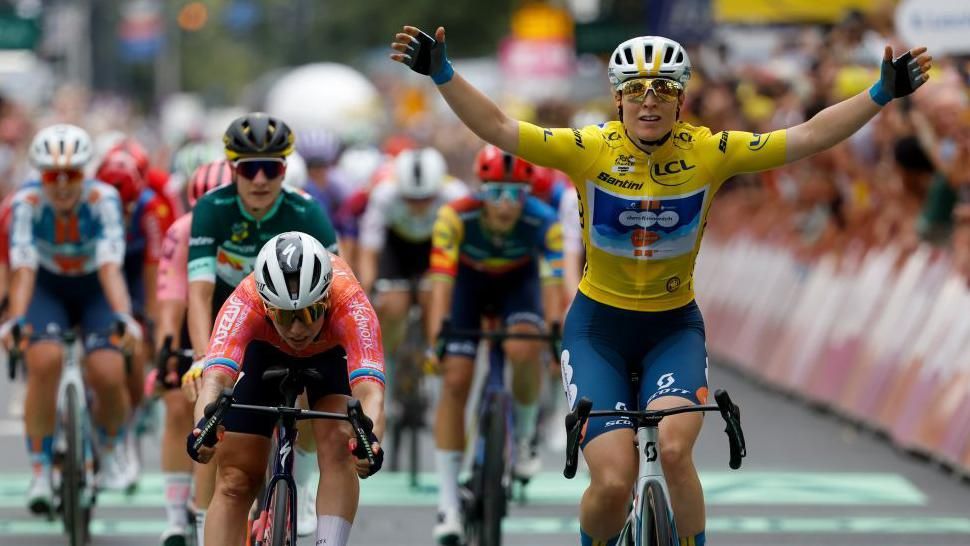 Dutch cyclist Charlotte Kool (right) raises her arms in celebration after beating Lorena Wiebes (left) to win stage two of the 2024 Tour de France Femmes