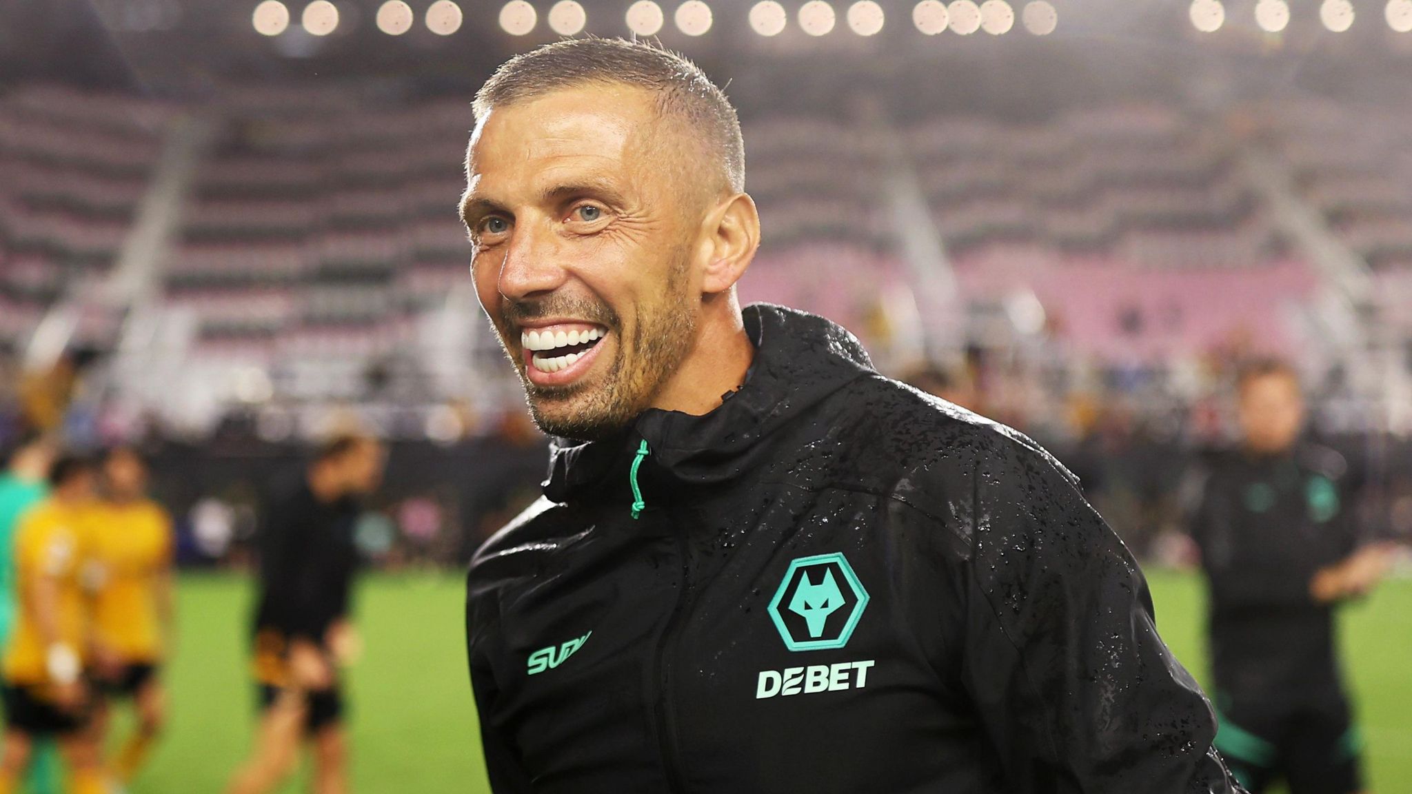 Gary O'Neil smiles while he wears Wolves' black training kit