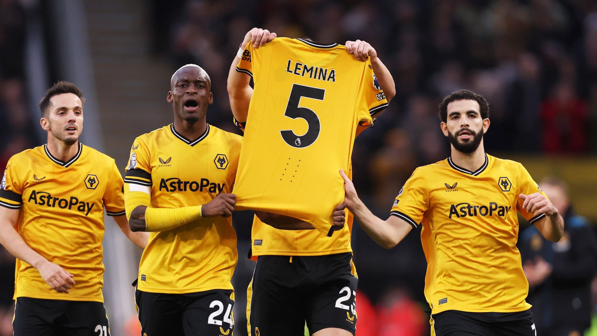 Max Kilman, hidden by the shirt, holds up a top with 'Lemina 5' on it. He is supported by Pablo Sarabia and Toti Gomes on his right and Rayan Ait-Nouri on the left. 