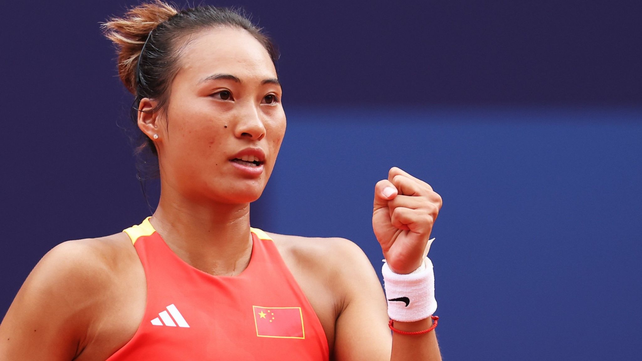 Zheng Qinwen celebrates winning a point during her Olympic final