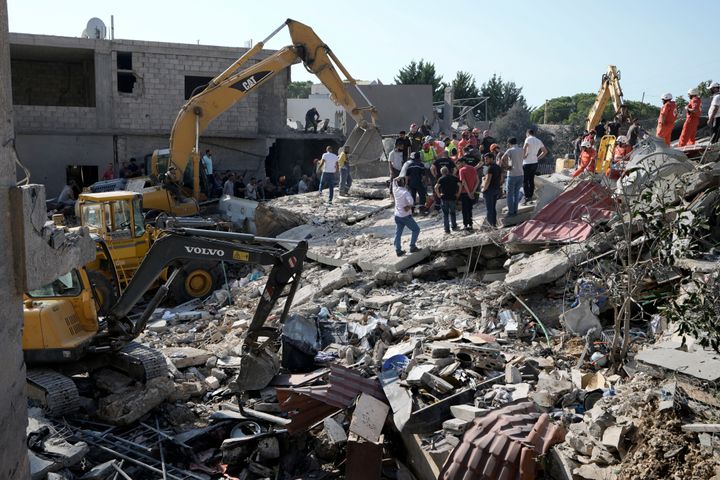 Emergency workers arrive at the scene of an Israeli airstrike in the town of Maisara, north of Beirut, Wednesday, Sept. 25, 2024. (AP Photo/Bilal Hussein)