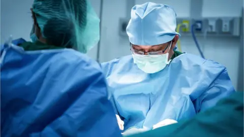 Getty Images Medical staff in surgical gowns working