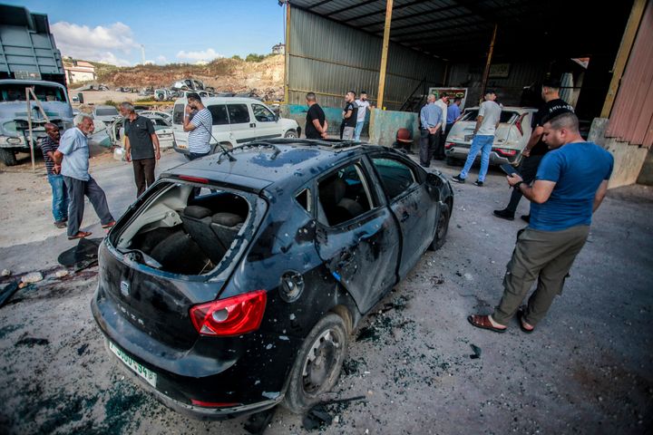 Palestinians look at a damaged car following an Israeli airstrike in Tubas, West Bank. Israel has been carrying out large-scale raids in the territory over the past week that it says are aimed at dismantling militant groups and preventing attacks.