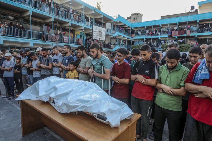 Palestinians perform a funeral prayer for UNRWA worker Yaser Abu Sharar and others who were killed Wednesday in an Israeli airstrike on the al-Jaouni school in the Nuseirat refugee camp in Deir al-Balah, Gaza.