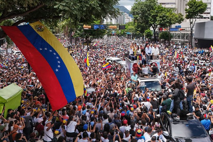 Opposition leader Maria Corina Machado and opposition candidate Edmundo Gonzalez ride atop a truck during a protest against official presidential election results declaring President Nicolas Maduro the winner in Caracas, Venezuela, Tuesday, July 30, 2024, two days after the vote. (AP Photo/Matias Delacroix)