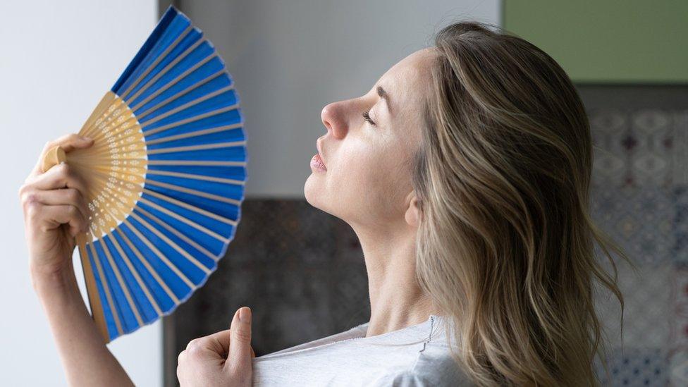 woman trying to stay cool in the heat