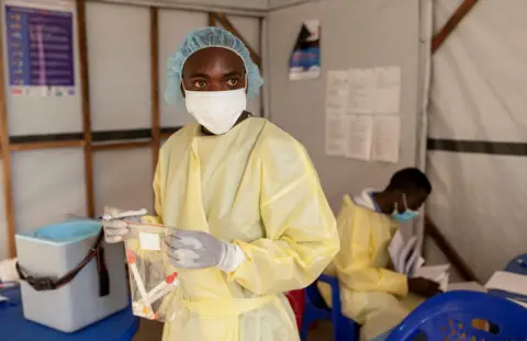 Reuters Christian Musema, a laboratory nurse, verifies samples taken from a child declared a suspected case of monkeypox virus that sparks off a painful rash, enlarged lymph nodes and fever; and recovered, collects water at the treatment centre in Munigi, following Mpox cases in Nyiragongo territory near Goma, North Kivu province, Democratic Republic of the Congo July 19, 2024