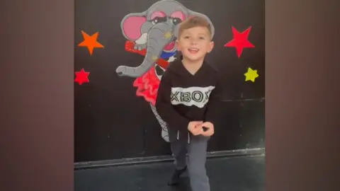 Joshua dancing and singing - image taken from a family video