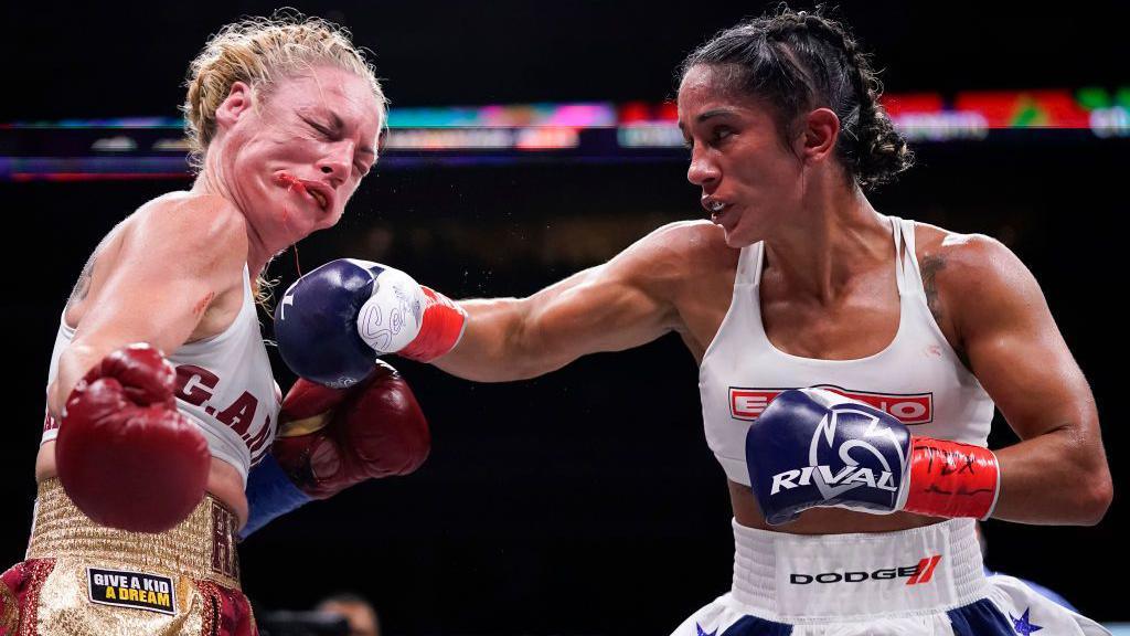 Heather Hardy's face is distorted after being punched by Amanda Serrano